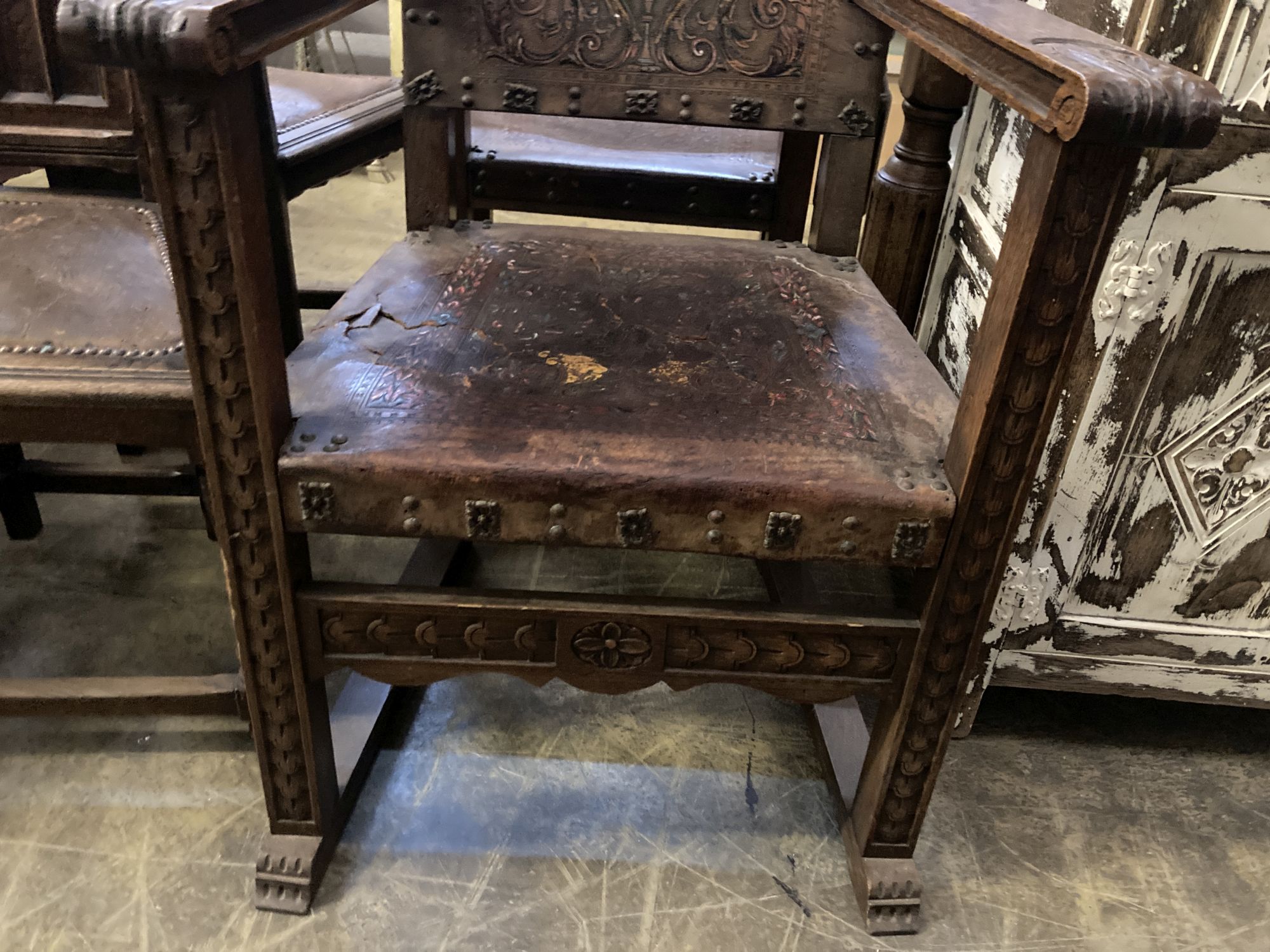 A pair of Spanish oak elbow chairs, width 62cm, depth 52cm, height 128cm